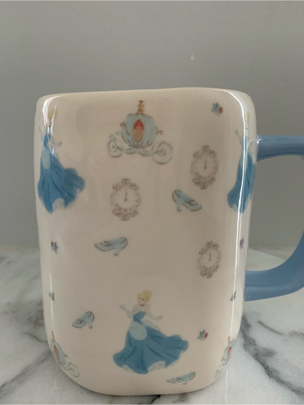 Rae Dunn White Mug with Blue Handle and Cinderella Motif